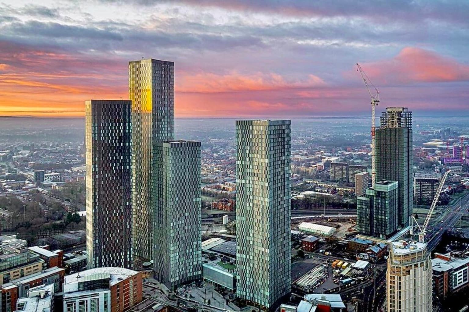 Deansgate Square and Elizabeth Tower in Manchester at sunset